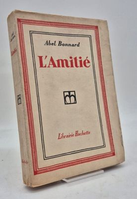 an old book sitting on top of a table on a white surface