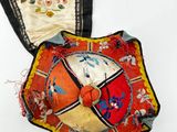 two pieces of cloth with a decorative design on them on a white surface