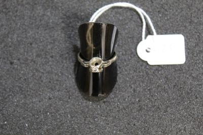 a ring with a skull on it sitting on a table