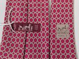 two ties with a label on them sitting on a table