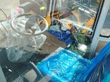 a blue plastic bag sitting on the ground next to a bus