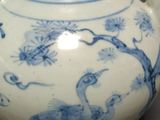 a blue and white vase with a bird design on it