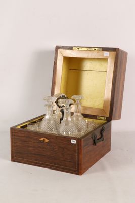 a wooden box with a set of wine glasses in it