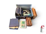a suitcase full of books sitting on a white surface