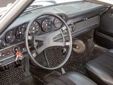 a dashboard and steering wheel of a car in a parking lot