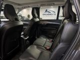 the back seats of a car in a showroom with a logo on the wall