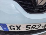a close up of the front of a car with a number plate on it