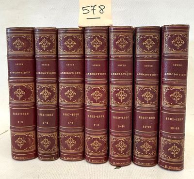 several books are stacked on top of each other on a table