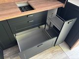a kitchen with a sink and drawers in it