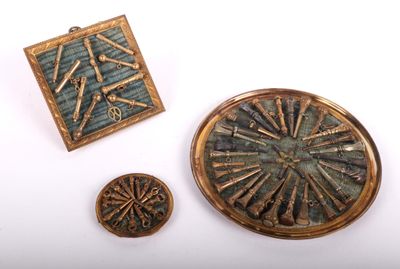 three pieces of metal and wood are sitting on a white surface