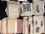 a pile of old newspapers sitting on a table