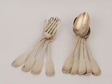 five silver spoons and two silver spoons on a white surface