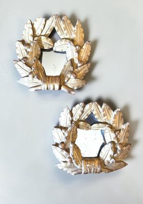 two mirrors that are on the wall next to each other