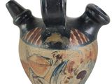 a black vase with a design on it on a white background