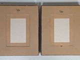 two picture frames on the wall next to each other