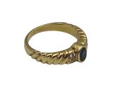 a close up of a gold ring with a blue stone