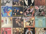 many different album covers are arranged on the floor