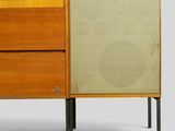 a close up of a cabinet with two drawers and one door open