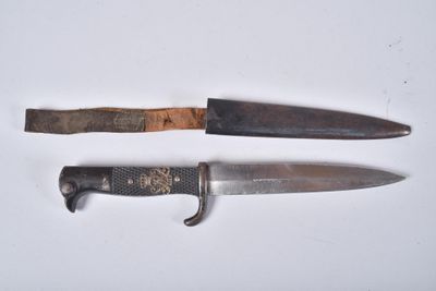 two knives are sitting next to each other on a white surface