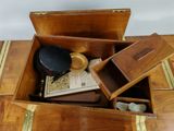 a small wooden box with a book and other items in it