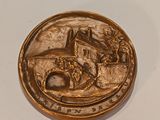 a gold coin with a picture of a castle on it
