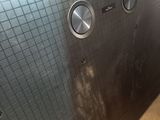 a close up of a metal door with three knobs on it