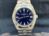 a close up of a watch with a blue dial on it