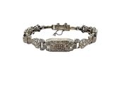 a silver bracelet with diamonds on a white background