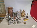 a table with a lot of silver and gold items on it