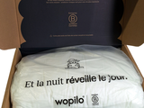 une boîte contenant un oreiller, sur fond blanc