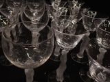 many empty wine glasses sitting on a black table