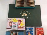 four tins of cigarettes in a green case