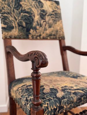 a wooden chair with a floral upholstered seat