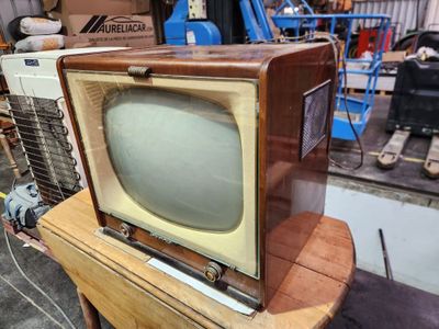 an old television sitting on top of a wooden table