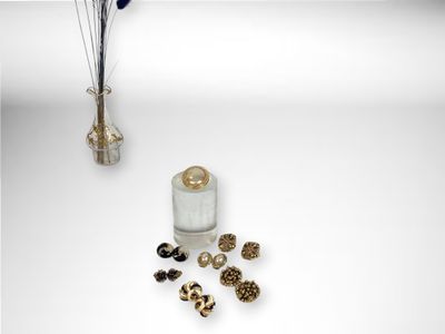 a vase of flowers and a bottle of perfume on a table