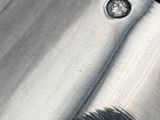a close up of a metal object with a screw on it