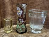 a vase and a glass sitting on a table
