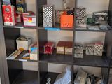 a book shelf with many items on it in a room