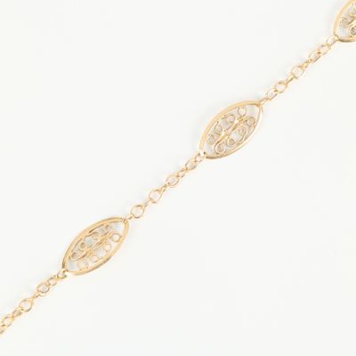 a gold chain bracelet with an intricate design