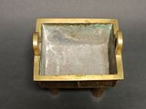 an image of a small brass box with a glass in it