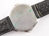 a close up of a watch on a white surface