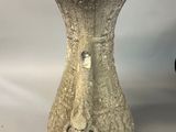 a stone vase that is sitting on a table