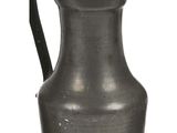 a small metal pitcher with a handle on a white background
