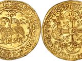 a gold coin with an image of a bird on it