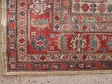 rug on the floor is red and blue with a pattern on it