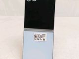 the back of a black and blue cell phone on a white surface
