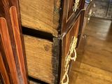 a close up of a chest of drawers on a wooden floor