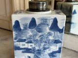 a blue and white vase sitting on a marble table