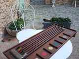 a table that has a wooden tray with paint on it