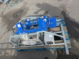 a blue machine that is sitting on top of a pallet